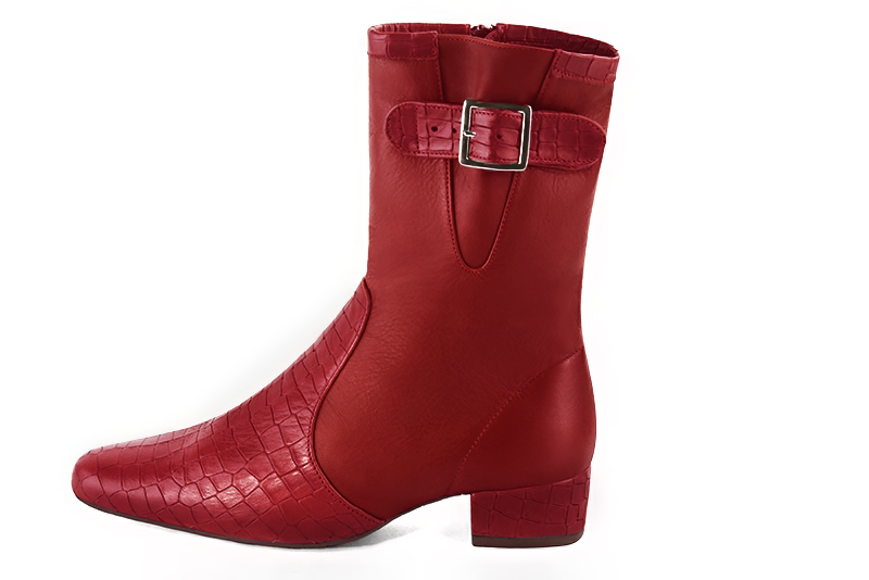 Scarlet red women's ankle boots with buckles on the sides. Round toe. Low block heels. Profile view - Florence KOOIJMAN
